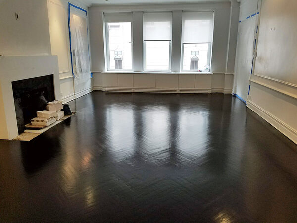 Dark herringbone hardwood floor in a living room