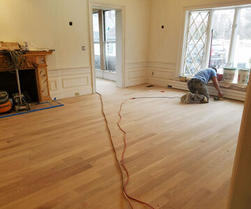 Floor refinishing — hardwood floor being sanded