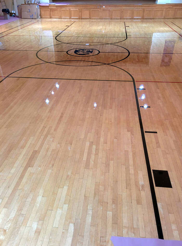 Gymnasium hardwood floor with game lines, commercial flooring project
