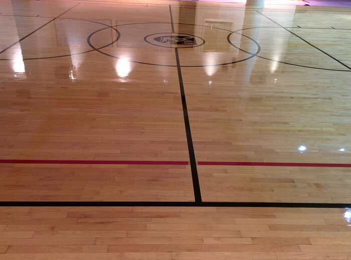 Finished gymnasium maple floor with painted game lines
