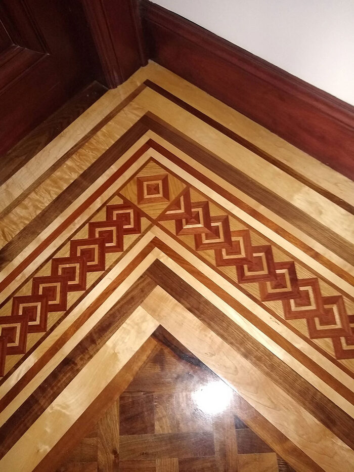 Custom chevron border inlay in contrasting wood species