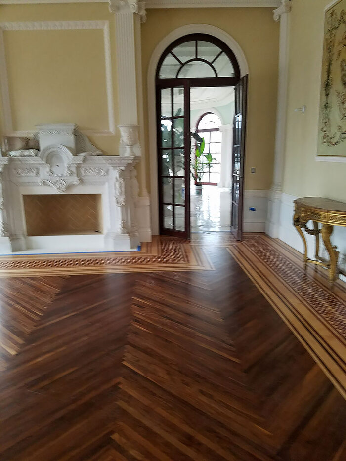 Herringbone floor with decorative border in an entry hall