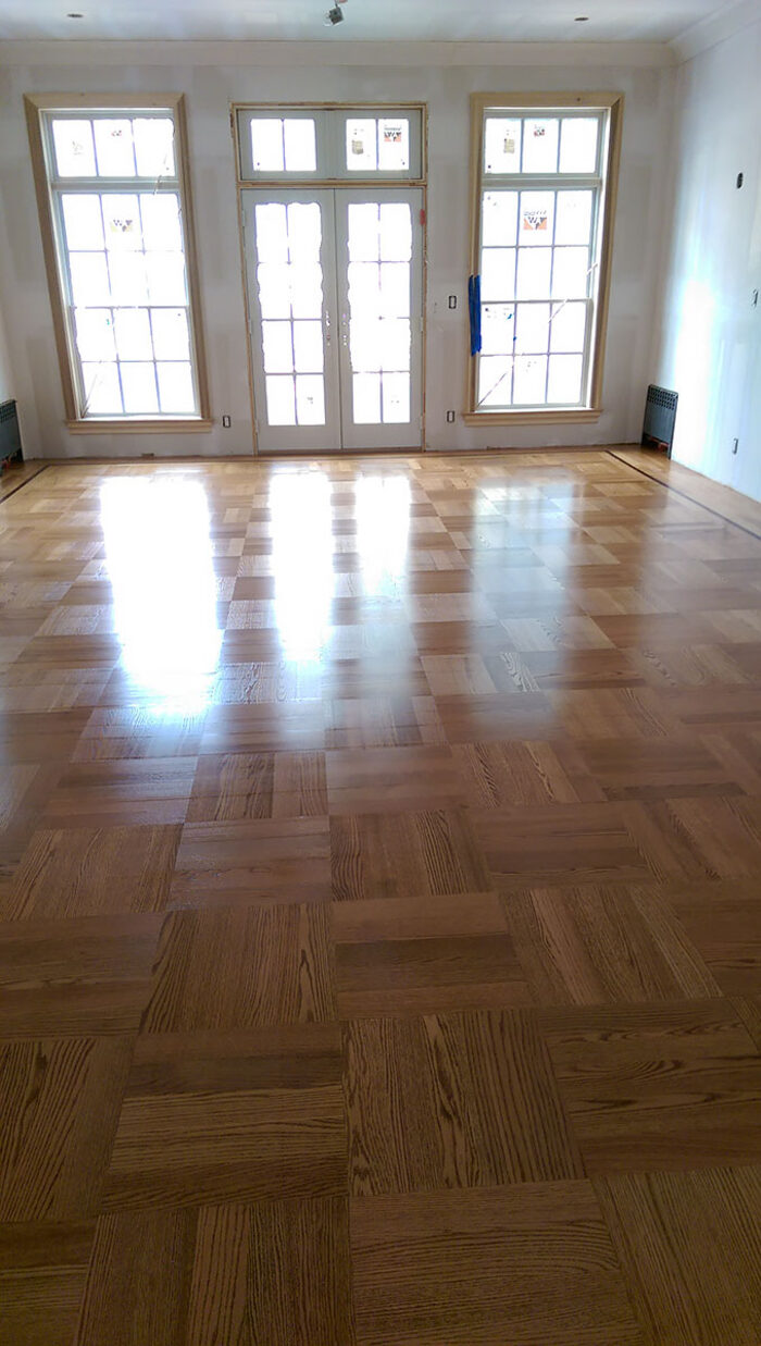 New parquet floor installation in a bright room